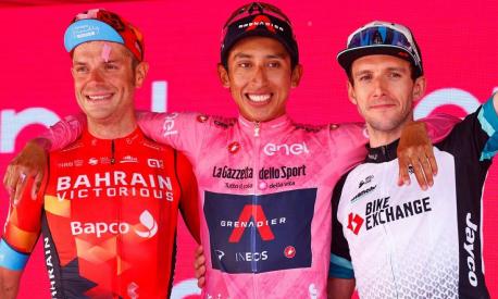 (From L) Overall second-placed Team Bahrain rider Italy's Damiano Caruso, Giro d'Italia 2021 winner Team Ineos rider Colombia's Egan Bernal and third-placed Team BikeExchange rider Great Britain's Simon Yates celebrate on the podium after the 21st and last stage on May 30, 2021 in Milan. (Photo by Luca Bettini / AFP)