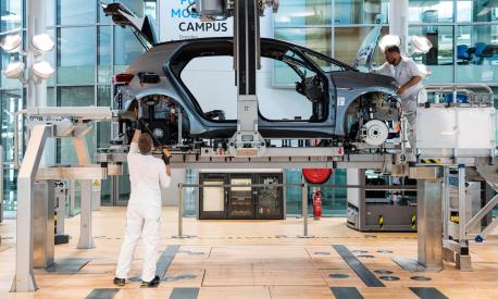 (FILES) In this file photograph taken on June 8, 2021, employees work on the assembly line for the Volkswagen (VW) ID 3 electric car of German carmaker Volkswagen, at the 'Glassy Manufactory' (Glaeserne Manufaktur) production site in Dresden, eastern Germany. - Electric cars -- key to reducing emissions and meeting climate change goals -- have boosted their market share in Europe, data showed July 23, 2021, as the region prepares to abandon petrol and diesel. Battery electric vehicles more than doubled their share of new car sales in Europe in the second quarter, according to the European Automobile Manufacturers' Association (ACEA) which groups together major car firms. (Photo by JENS SCHLUETER / AFP)