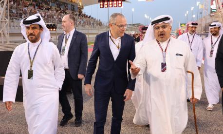 Stefano Domenicali (C) , CEO of the Formula One Group walks next to President of the International Automobile Federation (FIA) Mohammed ben Sulayem (L) prior the Bahrain Formula One Grand Prix at the Bahrain International Circuit in the city of Sakhir on March 20, 2022. (Photo by Giuseppe CACACE / POOL / AFP)
