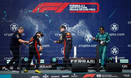 MIAMI, FLORIDA - MAY 07: Race winner Max Verstappen of the Netherlands and Oracle Red Bull Racing (second from right), Second placed Sergio Perez of Mexico and Oracle Red Bull Racing (second from left), Third placed Fernando Alonso of Spain and Aston Martin F1 Team (R) and Oliver Hughes, Chief Marketing Officer at Red Bull Racing (L) celebrate on the podium during the F1 Grand Prix of Miami at Miami International Autodrome on May 07, 2023 in Miami, Florida.   Jared C. Tilton/Getty Images/AFP (Photo by Jared C. Tilton / GETTY IMAGES NORTH AMERICA / Getty Images via AFP)