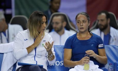Elisabetta Cocciaretto of Italy, right, listens to her coach Tathiana Garbin during a match against Jil Teichmann of Switzerland at the second day of the Billie Jean King Cup finals at Emirates Arena in Glasgow, Wednesday, Nov. 9, 2022. (AP Photo/Kin Cheung)