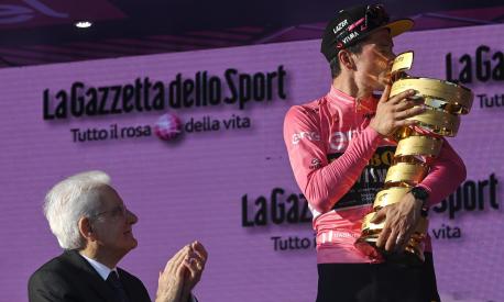 Slovenian rider and winner Primoz Roglic (R), kisses the trophy next to the Italian President of the Republic, Sergio Mattarella (L), after winning the 2023 Giro d'Italia cycling race, Rome, Italy, 28 May 2023. ANSA/RICCARDO ANTIMIANI