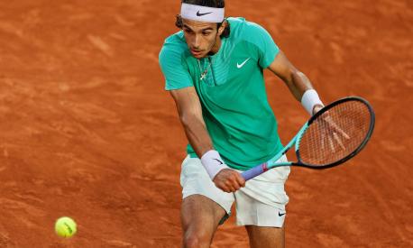 Italy's Lorenzo Musetti plays a backhand return to Russia's Alexander Shevchenko during their men's singles match on day four of the Roland-Garros Open tennis tournament at the Court Suzanne-Lenglen in Paris on May 31, 2023. (Photo by Geoffroy VAN DER HASSELT / AFP)