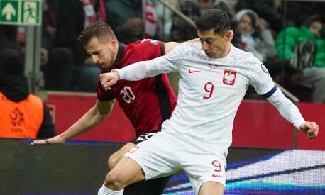 Poland's forward Robert Lewandowski and Albania's midfielder Ylber Ramadani vie for the ball during the UEFA Euro 2024 Group E qualification football match between Poland and Albania, in the PGE Narodowy in Warsaw, Poland, on March 27, 2023. (Photo by JANEK SKARZYNSKI / AFP)