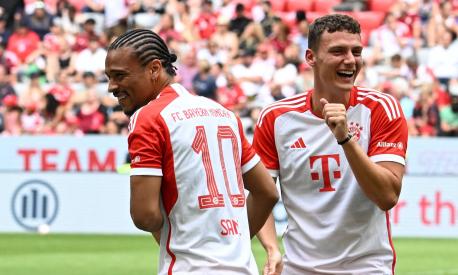 Bayern Munich's German midfielder Leroy Sane (L) and Bayern Munich's French defender Benjamin Pavard share a laugh during the team presentation of the German first division Bundesliga club Bayern Munich in the stadium in Munich, southern Germany, on July 23, 2023. (Photo by Christof STACHE / AFP)