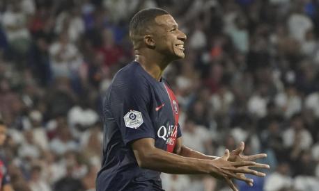 PSG's Kylian Mbappe celebrates after scoring his side's fourth goal during the French League One soccer match between Lyon and Paris Saint-Germain at the Groupama stadium, outside Lyon, France, Sunday, Sept. 3, 2023. (AP Photo/Laurent Cipriani)