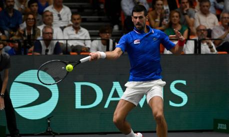 Serbia's Novak Djokovic returns a ball to Spain's Alejandro Davidovich Fokina during the group stage men's singles match between Spain and Serbia of the Davis Cup tennis tournament at the Fuente San Luis Sports Hall in Valencia on September 15, 2023. (Photo by JOSE JORDAN / AFP)