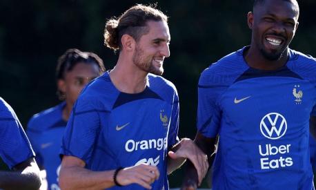 (From L) France's midfielder Adrien Rabiot (C) jokes with France's forward Marcus Thuram (R) during a training session in Clairefontaine-en-Yvelines on September 4, 2023 as part of the team's preparation for the upcoming UEFA Euro 2024 football tournament qualifying matches. France will play against Ireland on September 7, 2023, in the Group B of Euro 2024 qualifiers. (Photo by FRANCK FIFE / AFP)