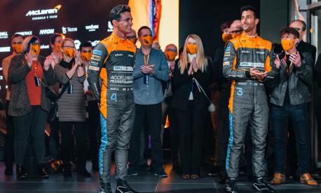A handout picture released on February 11, 2022 by McLaren shows British driver Lando Norris (centre left) and McLaren's Australian driver Daniel Ricciardo (3rd R) attending the launch of the McLaren MCL36 Formula One racing car for the 2022 season. (Photo by McLAREN / AFP) / RESTRICTED TO EDITORIAL USE - MANDATORY CREDIT "AFP PHOTO / MCLAREN" - NO MARKETING NO ADVERTISING CAMPAIGNS - DISTRIBUTED AS A SERVICE TO CLIENTS