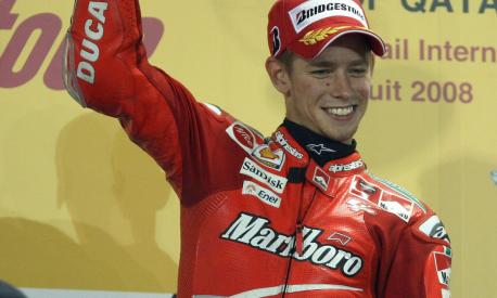 Australian rider Casey Stoner raises his trophy on the podium after winning the moto GP event at the Qatar Grand Prix in Doha on March 9, 2007. Defending world champion Casey Stoner of Australia, on a Ducati, won the season-opening Qatar Grand Prix here on Sunday, the first world championship race to be held at night. AFP PHOTO/KARIM JAAFAR