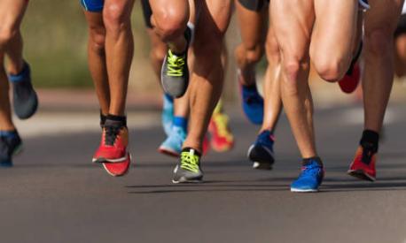 Marathon running race, people feet on city roa