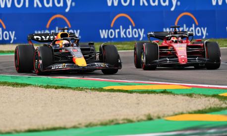 IMOLA, ITALY - APRIL 23: Max Verstappen of the Netherlands driving the (1) Oracle Red Bull Racing RB18 overtakes Charles Leclerc of Monaco driving (16) the Ferrari F1-75 for the lead during Sprint ahead of the F1 Grand Prix of Emilia Romagna at Autodromo Enzo e Dino Ferrari on April 23, 2022 in Imola, Italy. (Photo by Dan Mullan/Getty Images)