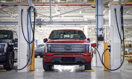 This handout photo released by Ford Motor Company on April 26, 2022 shows the F-150 Lightning at a charging station in the Rouge Electric Vehicle Center in Dearborne, Michighan. - Today marks the launch of the all-new, electric F-150 Lightning pickup  a milestone moment in Americas shift to electric vehicles. (Photo by FORD MOTOR COMPANY / AFP) / RESTRICTED TO EDITORIAL USE - MANDATORY CREDIT "AFP PHOTO / FORD Motor Company  / HANDOUT " - NO MARKETING - NO ADVERTISING CAMPAIGNS - DISTRIBUTED AS A SERVICE TO CLIENTS