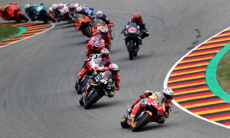 TOPSHOT - Honda Spanish rider Marc Marquez (Front) steers his motorbike during the German MotoGP Grand Prix at the Sachsenring racing circuit in Hohenstein-Ernstthal near Chemnitz, eastern Germany, on June 20, 2021. (Photo by Ronny HARTMANN / AFP)