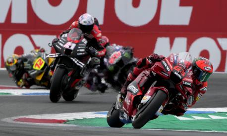 Italian rider Francesco Bagnaia of the Ducati Lenovo Team steers his motorcycle followed by Spain's rider Aleix Espargaro of the Aprilia Racing during the MotoGP race at the Dutch Grand Prix in Assen, northern Netherlands, Sunday, June 26, 2022. (AP Photo/Peter Dejong)