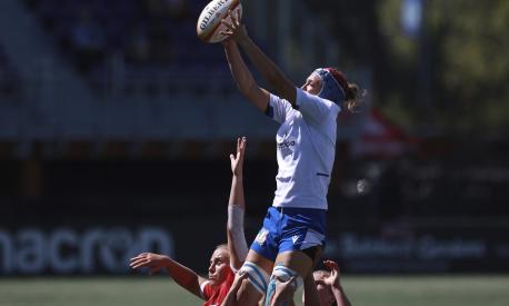 Team Canada players, botto, cannot stop the throw in as Team Italy's Elisa Giordano, top, makes a catch during first-half test match rugby action in Langford, British Columbia, Sunday, July 24, 2022. (Chad Hipolito/The Canadian Press via AP)