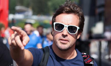 Alpine's Spanish driver Fernando Alonso gestures as he walks to the Paddock ahead of the Spa-Francorchamps racetrack on August 25, 2022. - The Formula One Belgian Grand Prix will take place on August 28, 2022. (Photo by Kenzo TRIBOUILLARD / AFP)