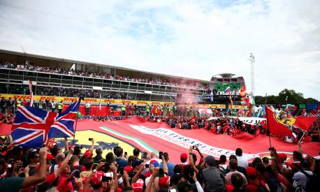 MONZA, ITALY - SEPTEMBER 02:  Fans enjoy the atmosphere as the drivers celebrate on the podium during the Formula One Grand Prix of Italy at Autodromo di Monza on September 2, 2018 in Monza, Italy.  (Photo by Dan Istitene/Getty Images)