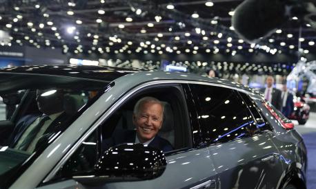 President Joe Biden drives a Cadillac Lyriq through the show room during a tour at the Detroit Auto Show, Wednesday, Sept. 14, 2022, in Detroit. (AP Photo/Evan Vucci)