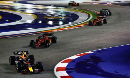 SINGAPORE, SINGAPORE - OCTOBER 02: Sergio Perez of Mexico driving the (11) Oracle Red Bull Racing RB18 leads Charles Leclerc of Monaco driving (16) the Ferrari F1-75 during the F1 Grand Prix of Singapore at Marina Bay Street Circuit on October 02, 2022 in Singapore, Singapore. (Photo by Mark Thompson/Getty Images,)