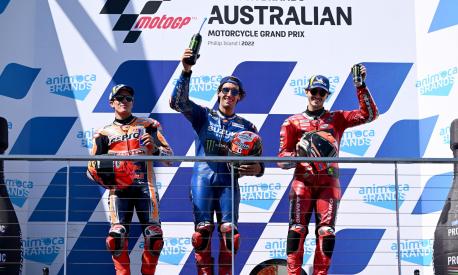 epa10246444 First place Alex Rins of Spain riding for Suzuki Ecstar (C) celebrates on the podium with second place Marc Marquez of Spain riding for Repsol Honda Team (L) and third place Francesco Bagnaia of Italy riding for Ducati Lenovo Team (R) after the MotoGP race  race at the Australian Motorcycle Grand Prix at the Phillip Island Grand Prix Circuit on Phillip Island, Victoria, Australia, 16 October 2022.  EPA/JOEL CARRETT AUSTRALIA AND NEW ZEALAND OUT