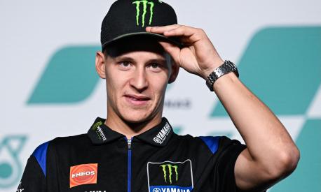 Monster Energy Yamaha MotoGP's French rider Fabio Quartararo adjusts his cap during a press conference at the Sepang International Circuit in Sepang on October 20, 2022, ahead of the practice sessions for the MotoGP Malaysia Grand Prix. (Photo by Mohd RASFAN / AFP)