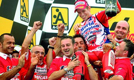 Casey Stoner of Australia, Ducati Marlboro team, is lifted by his team members as he celebrates his first world motorcycling championship title at the Japanese Grand Prix in Twin Ring Motegi, 23 September 2007.  Stoner won his first world motorcycling championship by finishing ahead of his archrival Valentino Rossi in the MotoGP race at the Japanese Grand Prix.   AFP PHOTO / KAZUHIRO NOGI