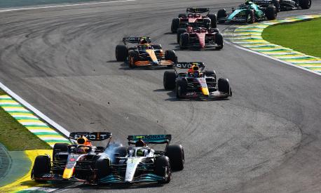 SAO PAULO, BRAZIL - NOVEMBER 13: Max Verstappen of the Netherlands driving the (1) Oracle Red Bull Racing RB18 and Lewis Hamilton of Great Britain driving the (44) Mercedes AMG Petronas F1 Team W13 collide during the F1 Grand Prix of Brazil at Autodromo Jose Carlos Pace on November 13, 2022 in Sao Paulo, Brazil. (Photo by Mark Thompson/Getty Images)