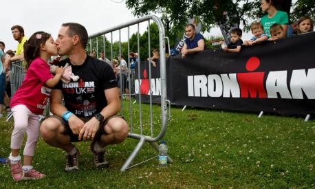 SOMERSET, UNITED KINGDOM - JUNE 24:  A father kisses his daughter prior to start the Iron Kids race the day before of Ironman 70.3 UK Exmoor at Wimbleball Lake on June 24, 2017 in Somerset, United Kingdom.  (Photo by Gonzalo Arroyo Moreno/Getty Images for Ironman)