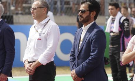FIA president Mohammed bin Sulayem, right, stands during a tribute for Red Bull team owner Dietrich Mateschitz before the F1 U.S. Grand Prix auto race at Circuit of the Americas, Sunday, Oct. 23, 2022, in Austin, Texas. (AP Photo/Shawn Thew, Pool)