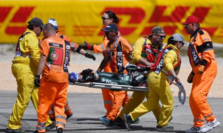 Track staff members carry Aprilia Portuguese rider Miguel Oliveira on a stretcher after crashing during the MotoGP race of the Portuguese Grand Prix at the Algarve International Circuit in Portimao, on March 26, 2023. (Photo by PATRICIA DE MELO MOREIRA / AFP)