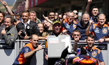 Moto2 rider Pedro Acosta of Spain poses with his team after winning the Portugal Motorcycle Grand Prix, at the Algarve International circuit near Portimao, Portugal, Sunday, March 26, 2023. (AP Photo/Jose Breton)