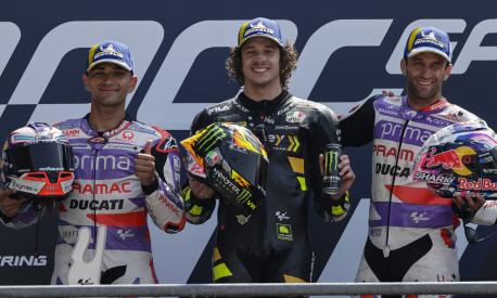 Moto GP race winner Italian rider Marco Bezzecchi of the Mooney VR46 Racing Team, center, poses with second placed Spain's rider Jorge Martin of the Prima Pramac Racing, left, and third placed France's rider Johann Zarco of the Prima Pramac Racing after the MotoGP race of the French Motorcycle Grand Prix at the Le Mans racetrack, in Le Mans, France, Sunday, May 14, 2023. (AP Photo/Jeremias Gonzalez)