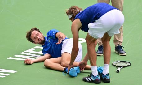 TOPSHOT - Daniil Medvedev of Russia reacts as Alexander Zverev of Germany touches his foot after Medvedev fell during second set action in their fourth round tennis match at the 2023 ATP Indian Wells Masters on March 14, 2023 in Indian Wells, California. (Photo by Frederic J. BROWN / AFP)