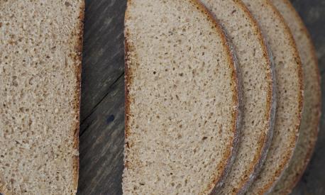 close up of fresh sliced brown bread on the table