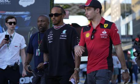 Mercedes driver Lewis Hamilton of Britain, left, and Ferrari driver Charles Leclerc of Monaco arrive to speak to media ahead of the Formula On Saudi Arabian Grand Prix in Jeddah, Saudi Arabia, Thursday, March 16, 2023. (AP Photo/Hassan Ammar)
