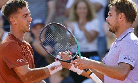Australia's Thanasi Kokkinakis, left, and Switzerland's Stan Wawrinka shake hands after their second round match of the French Open tennis tournament at the Roland Garros stadium in Paris, Wednesday, May 31, 2023. (AP Photo/Jean-Francois Badias)