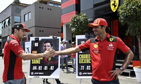 Ferrari's Monegasque driver Charles Leclerc (L) and Ferrari's Spanish driver Carlos Sainz Jr greet each other before a press conference ahead of the Spanish Formula One Grand Prix at the Circuit de Catalunya on June 1, 2023 in Montmelo, on the outskirts of Barcelona. (Photo by JAVIER SORIANO / AFP)