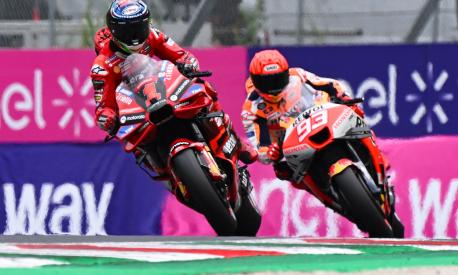 Ducati Italian rider Francesco Bagnaia (L) competes to claim the pole position ahead of Honda Spanish rider Marc Marquez during the qualifying rounds ahead of the Italian MotoGP race at Mugello Circuit in Mugello, on June 10, 2023. (Photo by Filippo MONTEFORTE / AFP)