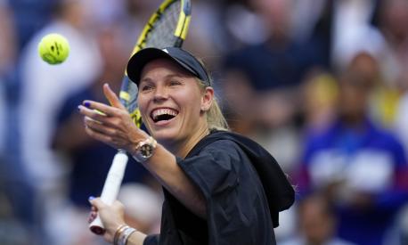 Caroline Wozniacki, of Denmark, hits balls to fans after defeating Jennifer Brady, of the United States, during the third round of the U.S. Open tennis championships, Friday, Sept. 1, 2023, in New York. (AP Photo/Manu Fernandez)