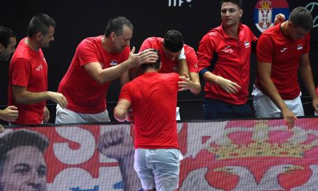 Serbia's Dusan Lajovic (C) is congratulated by teammates for beating South Korea's Seong-chan Hong during the group stage men's singles match between Serbia and South Korea of the Davis Cup tennis tournament at the Fuente San Luis Sports Hall in Valencia on September 12, 2023. (Photo by JOSE JORDAN / AFP)