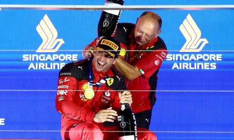 SINGAPORE, SINGAPORE - SEPTEMBER 17: Race winner Carlos Sainz of Spain and Ferrari celebrates with Ferrari Team Principal Frederic Vasseur on the podium during the F1 Grand Prix of Singapore at Marina Bay Street Circuit on September 17, 2023 in Singapore, Singapore. (Photo by Clive Rose/Getty Images)