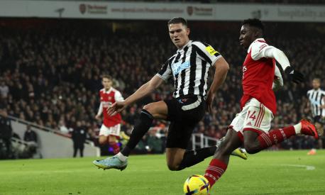Newcastle's Sven Botman, left, tries to block a shot from Arsenal's Eddie Nketiah during the English Premier League soccer match between Arsenal and Newcastle United at Emirates stadium in London, Tuesday, Jan. 3, 2023. (AP Photo/Ian Walton)