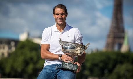 epa09998724 Rafael Nadal of Spain poses with his trophy by the Eiffel Tower after winning the Men's final match at the Roalnd Garros French Open tennis tournament in Paris, France, 06 June 2022. Nadal won his fourteenth Roland Garros tournament on 05 June 2022.  EPA/CHRISTOPHE PETIT TESSON