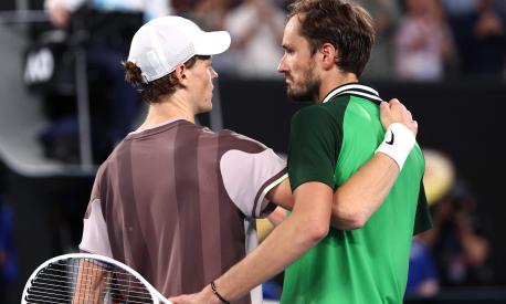 Italy's Jannik Sinner embraces Russia's Daniil Medvedev (R) after his victory in the men's singles final match on day 15 of the Australian Open tennis tournament in Melbourne on January 28, 2024. (Photo by David GRAY / AFP) / -- IMAGE RESTRICTED TO EDITORIAL USE - STRICTLY NO COMMERCIAL USE --