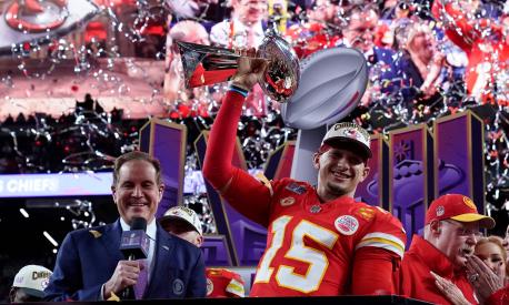 Kansas City Chiefs' quarterback #15 Patrick Mahomes celebrates with the trophy after the Chiefs won Super Bowl LVIII against the San Francisco 49ers at Allegiant Stadium in Las Vegas, Nevada, February 11, 2024. (Photo by TIMOTHY A. CLARY / AFP)