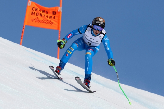 Italy's Federica Brignone speeds down the course during an alpine ski, women's World Cup Super G, in Crans Montana, Switzerland, Saturday, Jan. 31, 2026. (Jean-Christophe Bott/Keystone via AP)