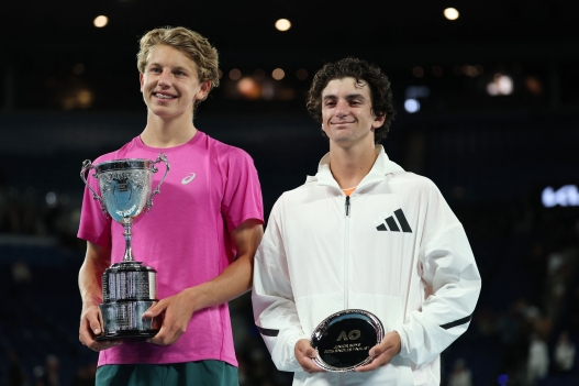 Winner Slovenia's Ziga Sesko (L) and runner-up USA's Keaton Hance pose with their trophes after Sesko's victory in their boy's junior singles final match on day fifteen of the Australian Open tennis tournament in Melbourne on February 1, 2026. (Photo by Martin KEEP / AFP) / -- IMAGE RESTRICTED TO EDITORIAL USE - STRICTLY NO COMMERCIAL USE --