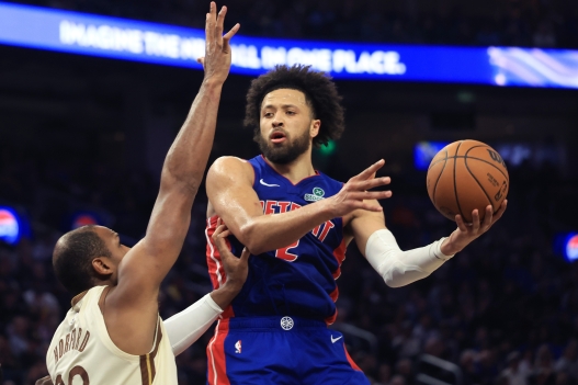 Detroit Pistons guard Cade Cunningham, right, looks to pass the ball against Golden State Warriors center Al Horford, left, during the first half of an NBA basketball game in San Francisco, Friday, Jan. 30, 2026. (AP Photo/Jed Jacobsohn)