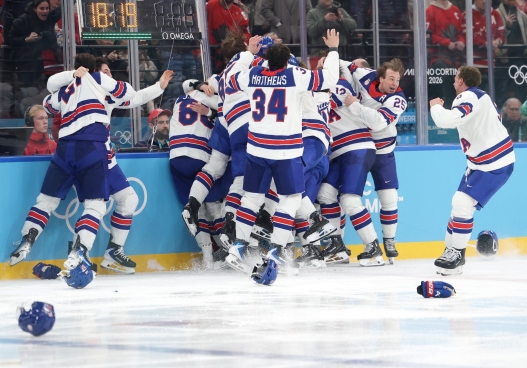 epa12768732 USA players celebrate after scoring the winning goal during the Men's Ice Hockey final match between Canada and the USA at the Milano Cortina 2026 Winter Olympic Games in Milano, Italy, 22 February 2026. EPA/FAZRY ISMAIL
